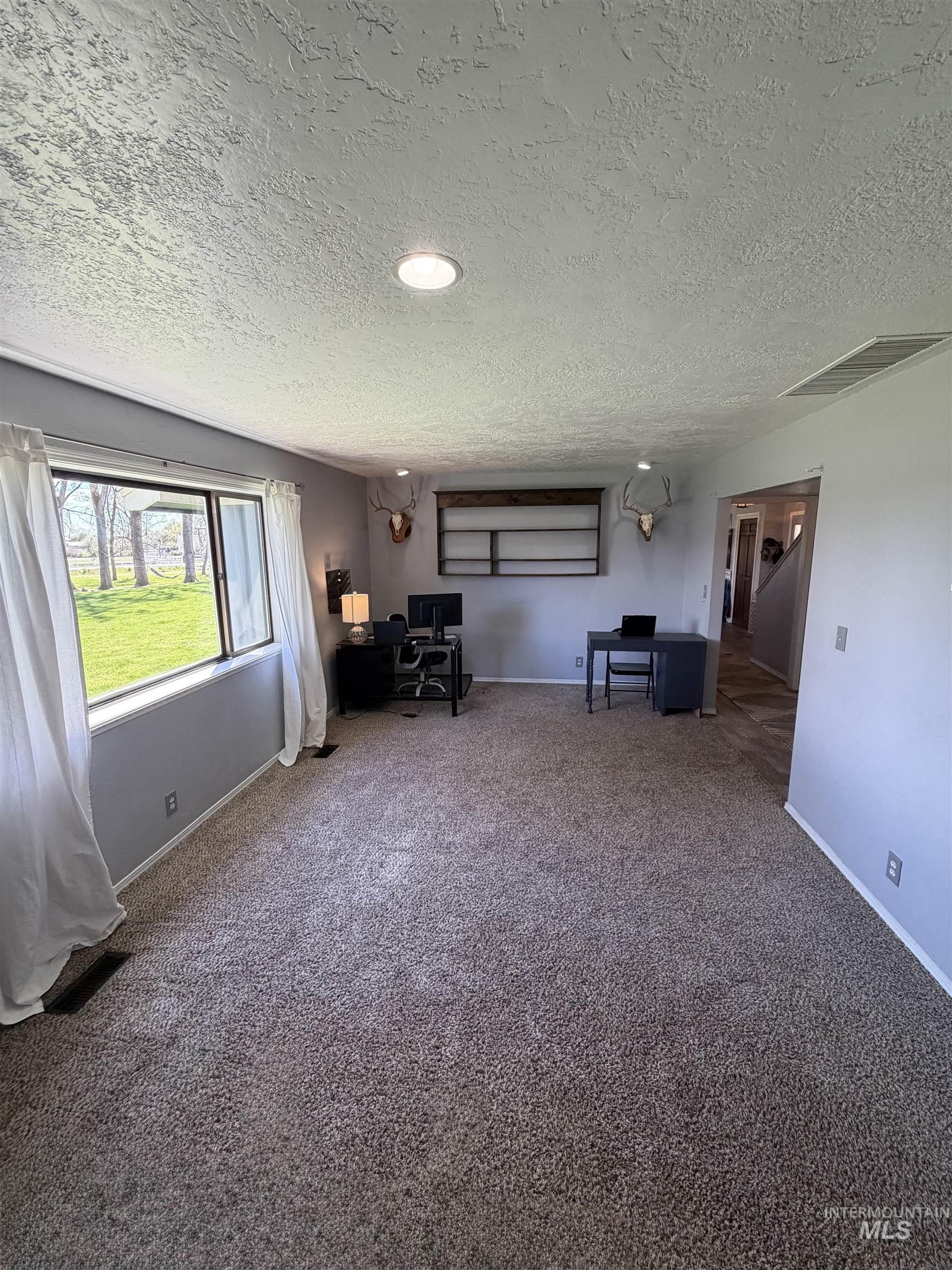 1452 Weiser River Road Weiser, ID 83672 - Photo 12 of 40 Sitting room featuring carpet and a textured ceiling