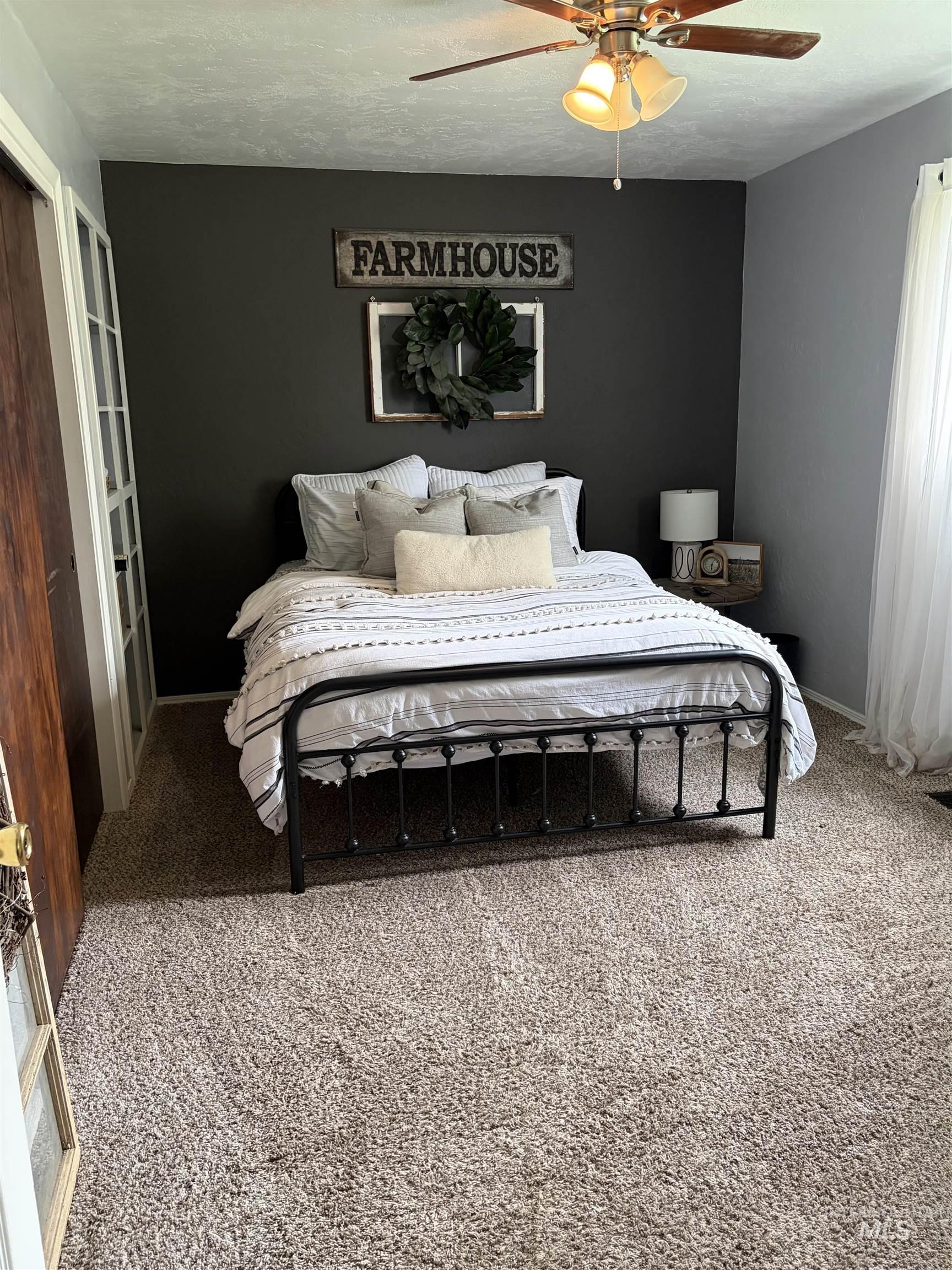 1452 Weiser River Road Weiser, ID 83672 - Photo 15 of 40 Carpeted bedroom featuring ceiling fan and a textured ceiling