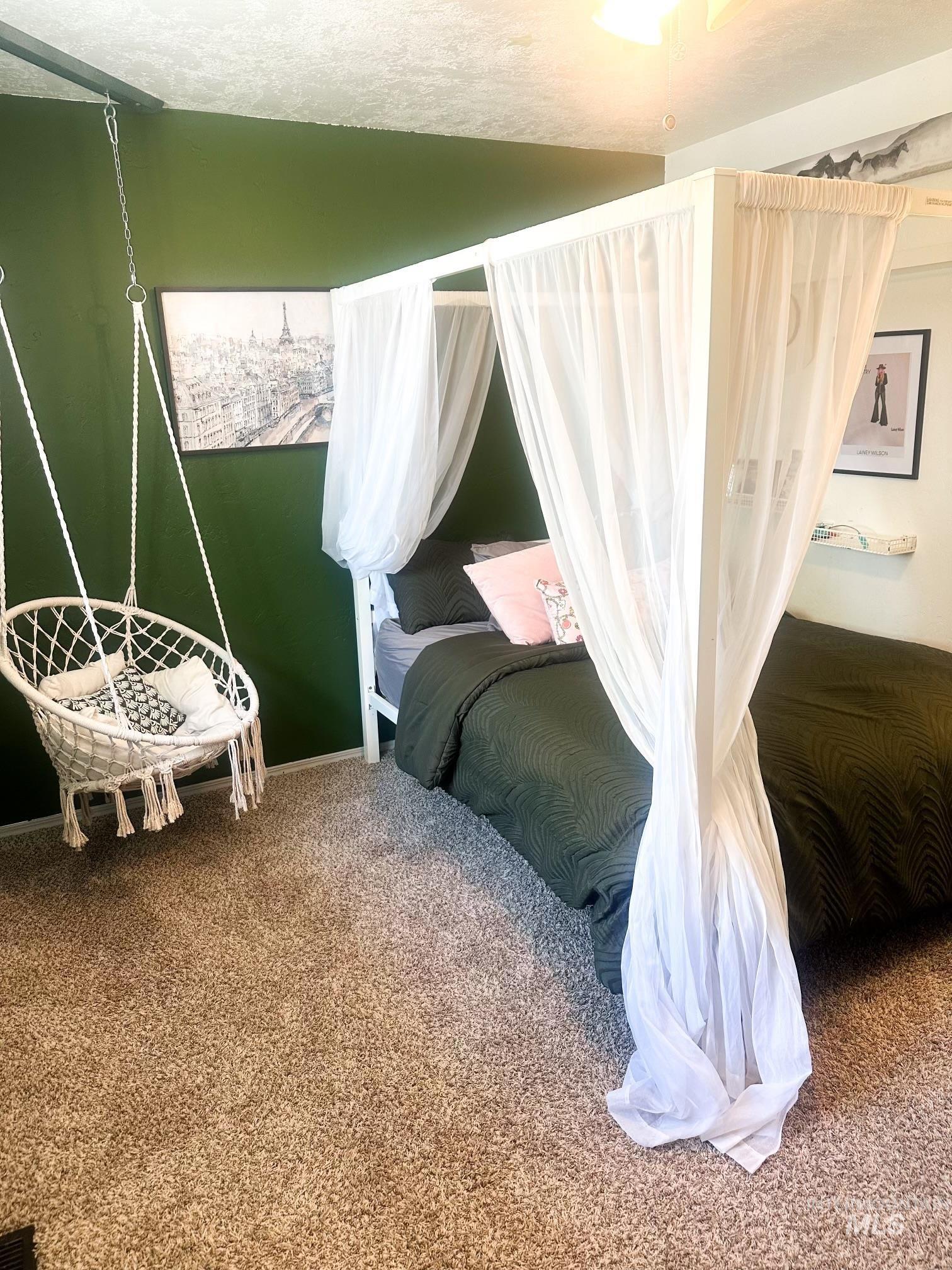 1452 Weiser River Road Weiser, ID 83672 - Photo 16 of 38 Wall-to-wall carpeting and a dark green accent wall define this bedroom space