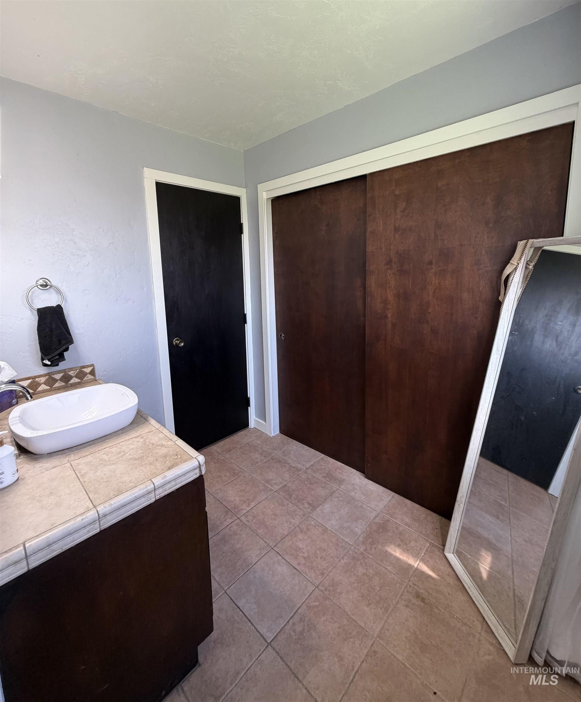 1452 Weiser River Road Weiser, ID 83672 - Photo 19 of 40 Bathroom featuring vanity and light tile patterned floors