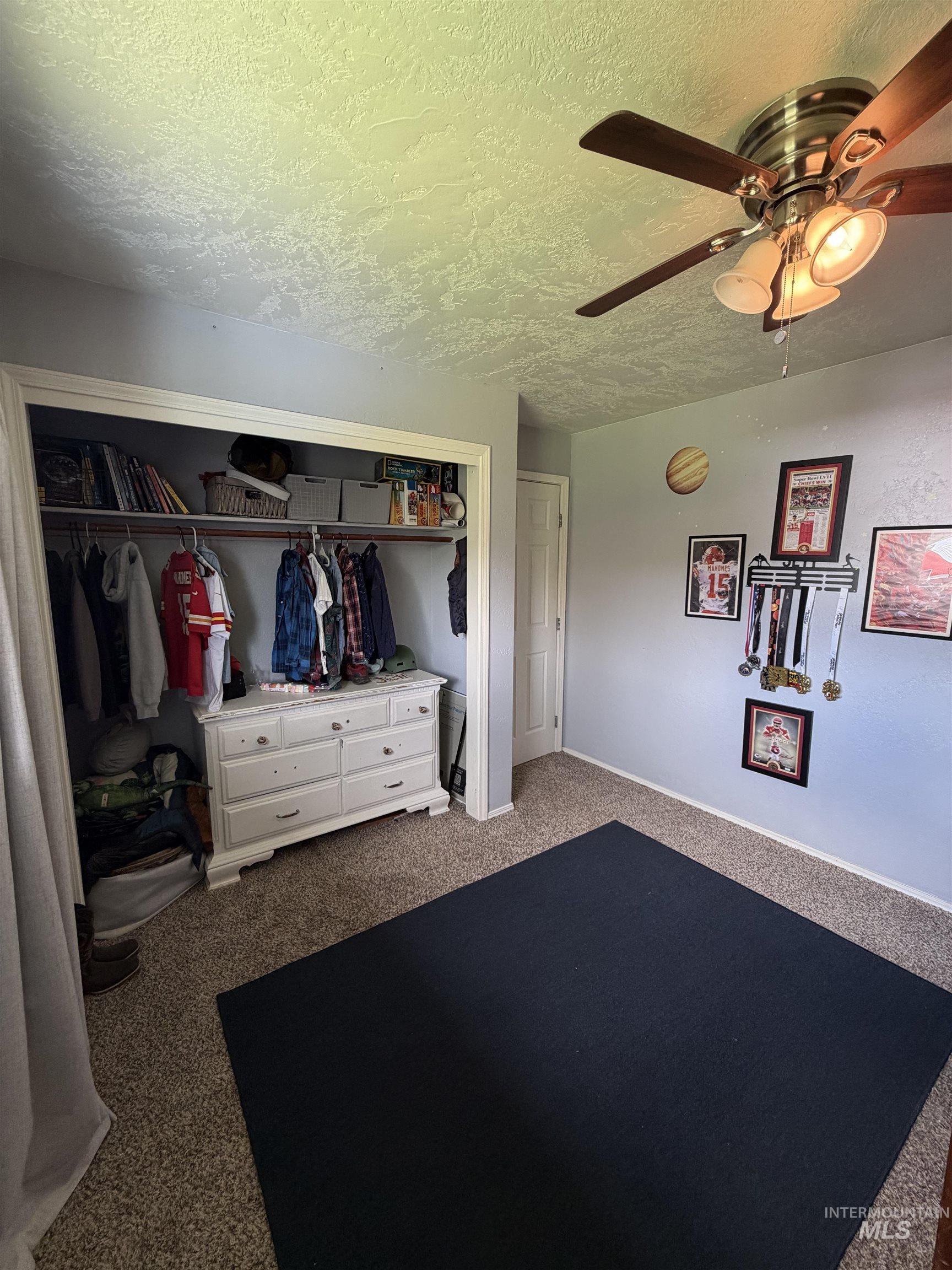 1452 Weiser River Road Weiser, ID 83672 - Photo 26 of 40 Bedroom with a closet, carpet, a textured ceiling, and a ceiling fan