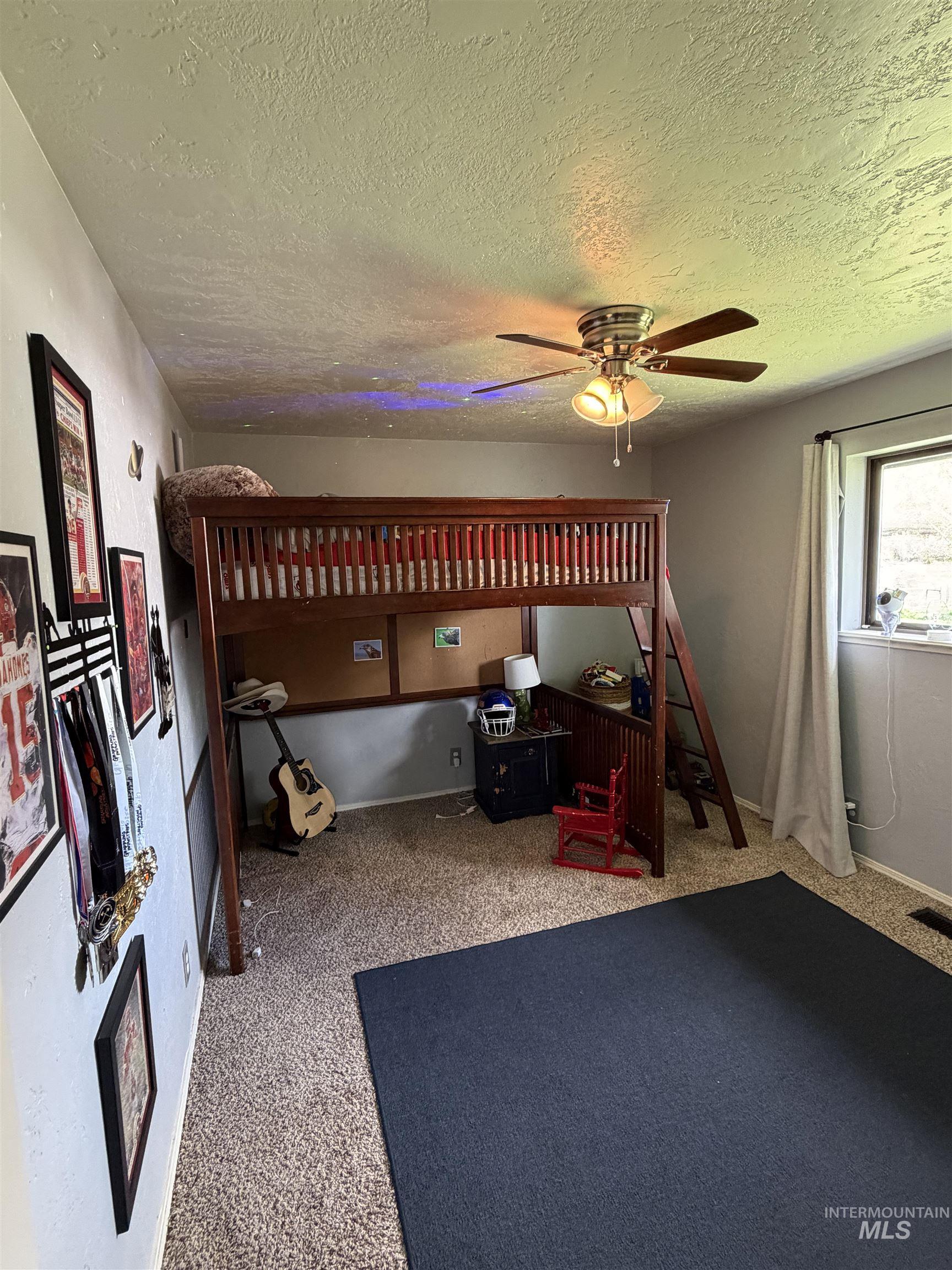 1452 Weiser River Road Weiser, ID 83672 - Photo 27 of 40 Bedroom with a textured ceiling, light colored carpet, and a ceiling fan