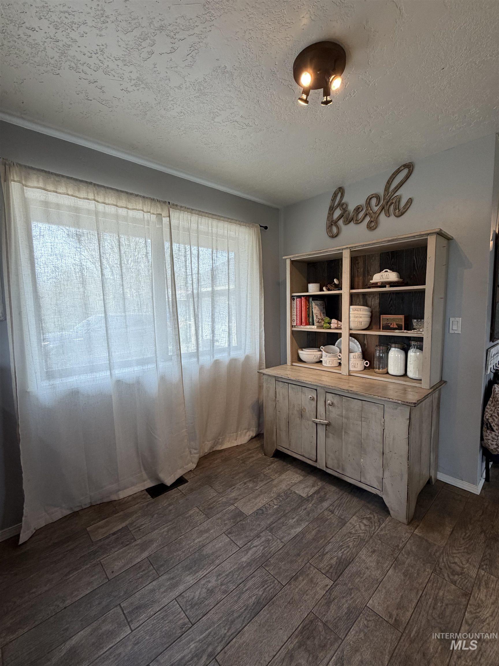 1452 Weiser River Road Weiser, ID 83672 - Photo 9 of 40 Dining area with dark wood-style floors and a textured ceiling