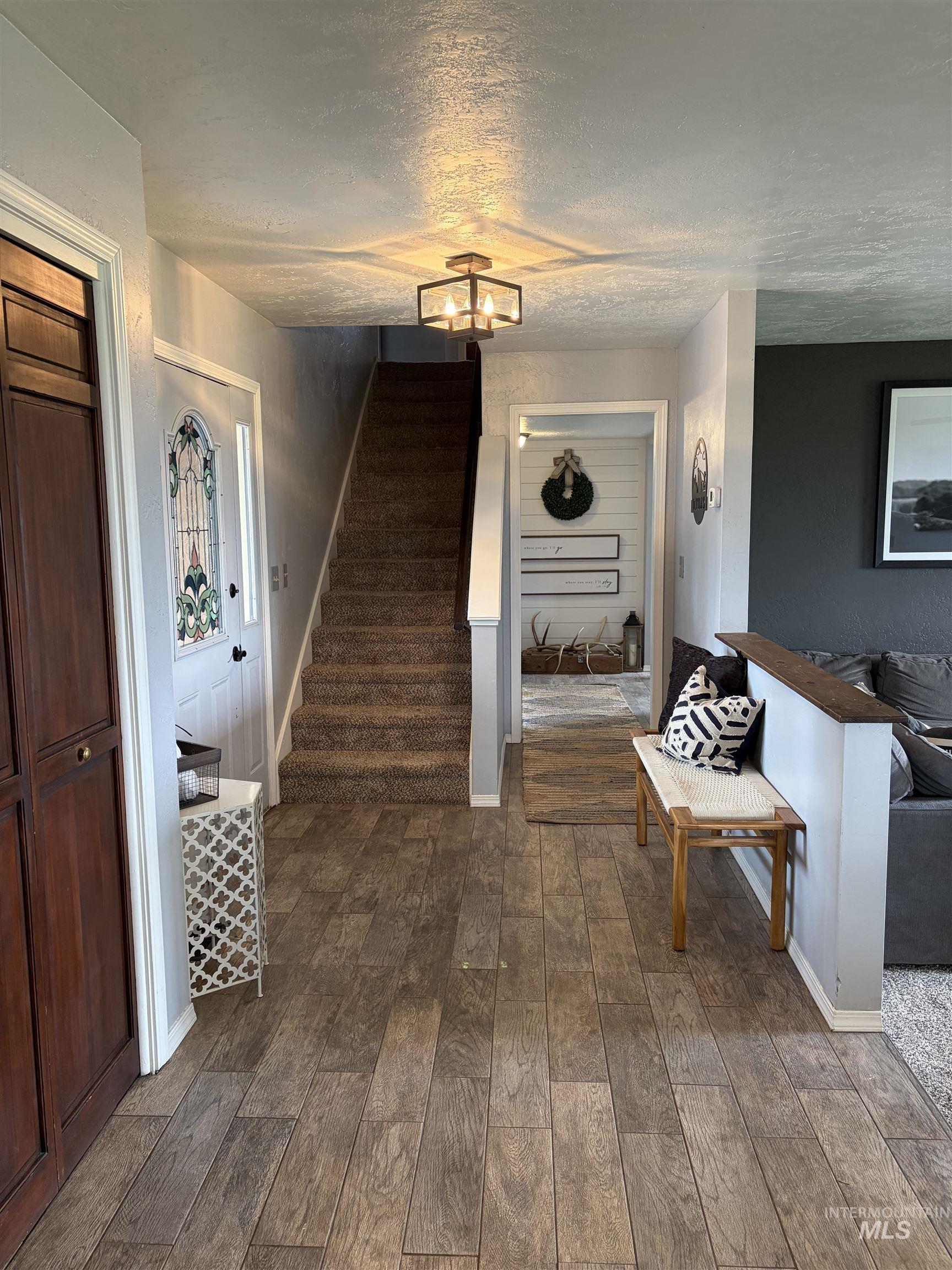 1452 Weiser River Road Weiser, ID 83672 - Photo 10 of 40 Corridor with dark wood-type flooring and a textured ceiling