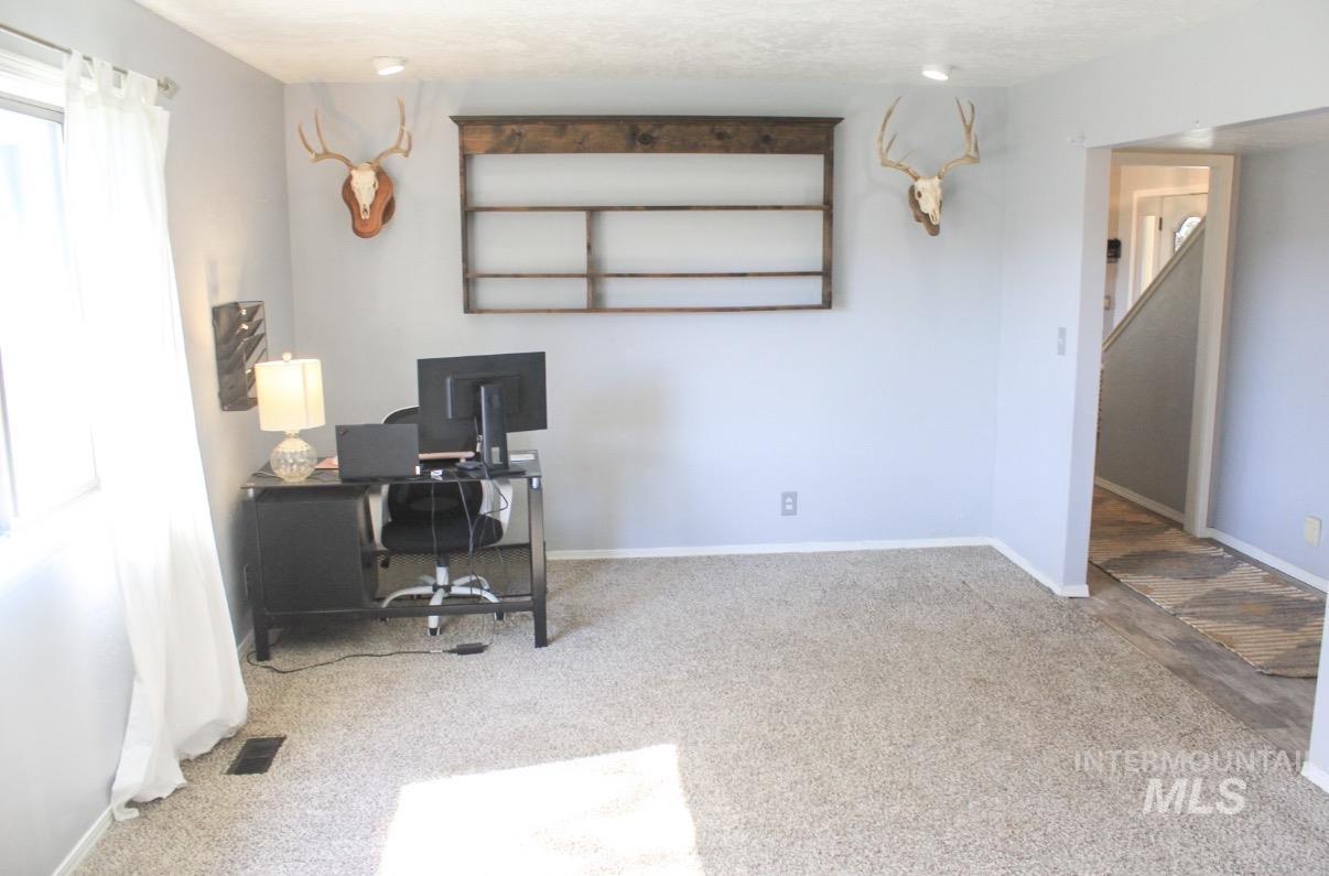 1452 Weiser River Road Weiser, ID 83672 - Photo 10 of 38 Neutral-toned carpeting spans the room, complemented by light gray wall paint