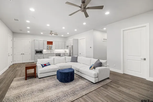 a living room with furniture and kitchen view