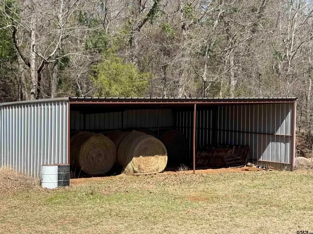 a view of wooden fence and a house in the background