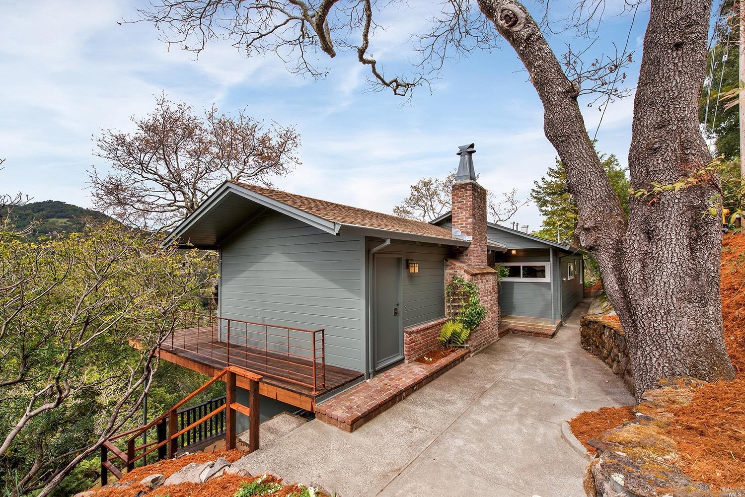 a small barn with a big yard and a large tree
