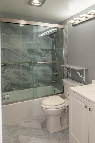 a bathroom with a toilet and a shower