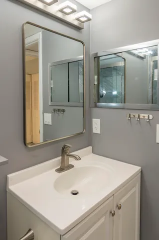 a bathroom with a sink and a mirror