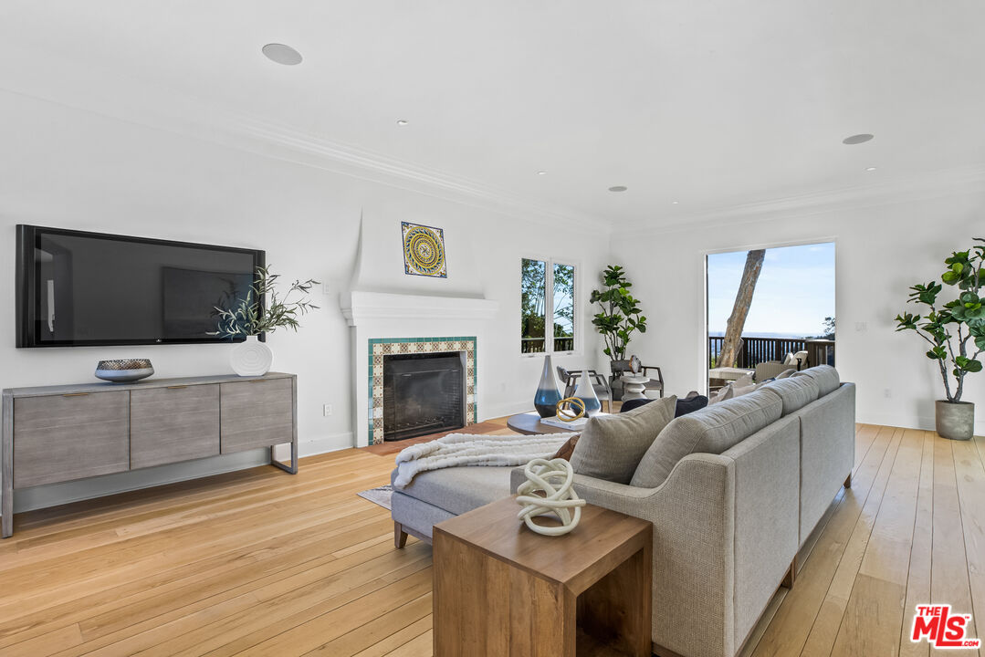 2201 Malaga Road Los Angeles, CA 90068 - Photo 16 of 51 a living room with furniture a flat screen tv and a fireplace
