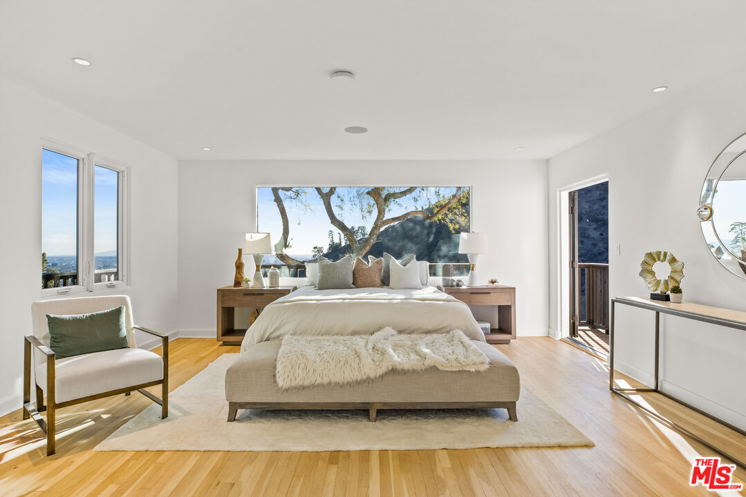 2201 Malaga Road Los Angeles, CA 90068 - Photo 30 of 51 a bedroom with a large bed and a chandelier