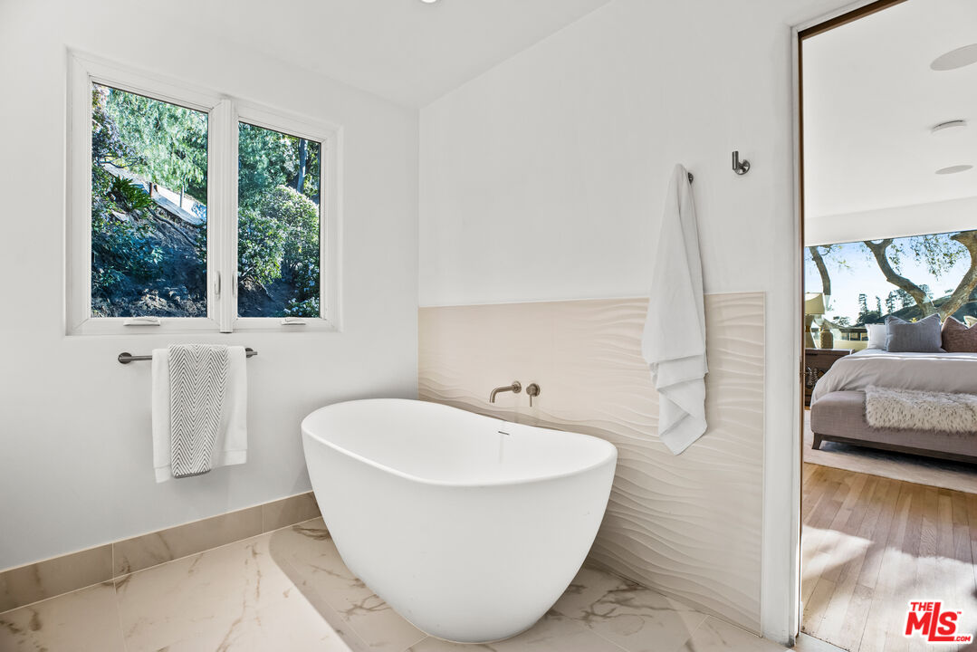 2201 Malaga Road Los Angeles, CA 90068 - Photo 38 of 51 a white bath tub sitting in a bathroom next to a window