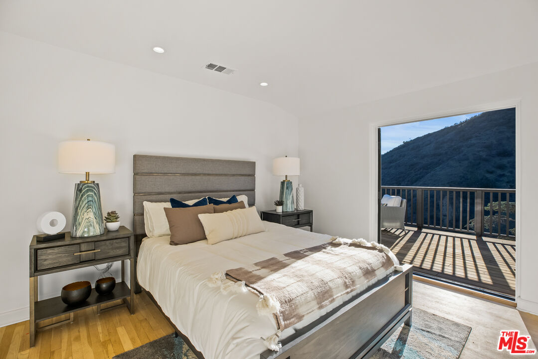 2201 Malaga Road Los Angeles, CA 90068 - Photo 40 of 51 a bedroom with a bed and wooden floor