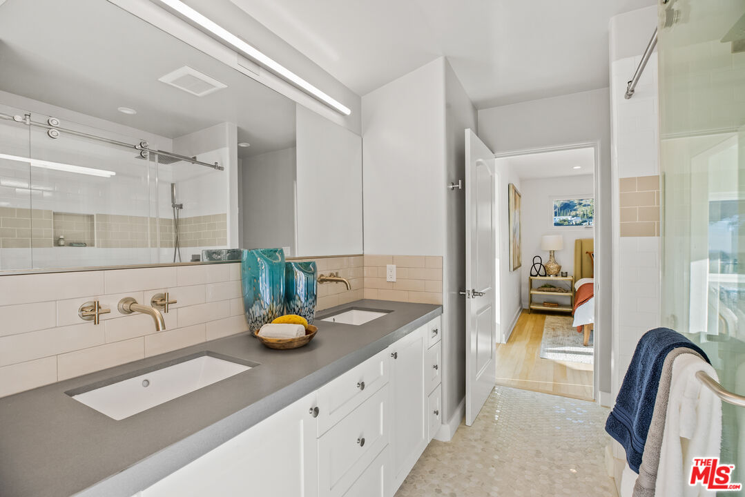 2201 Malaga Road Los Angeles, CA 90068 - Photo 41 of 51 a bathroom with a granite countertop sink and a mirror
