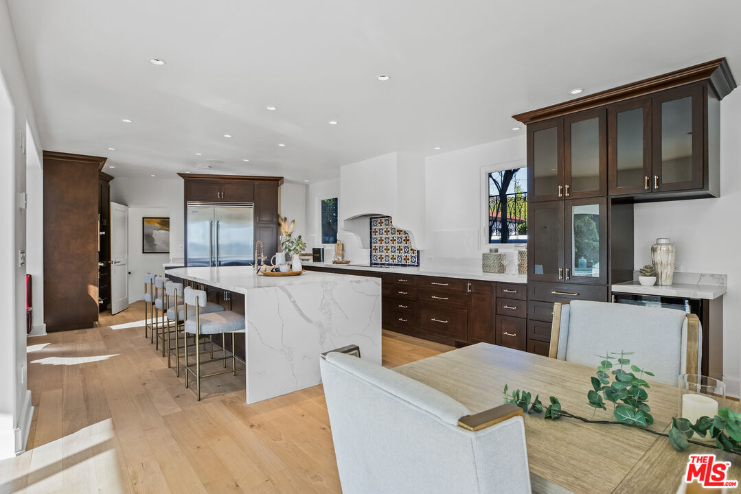 2201 Malaga Road Los Angeles, CA 90068 - Photo 7 of 51 a kitchen with stainless steel appliances kitchen island granite countertop a table and chairs in it