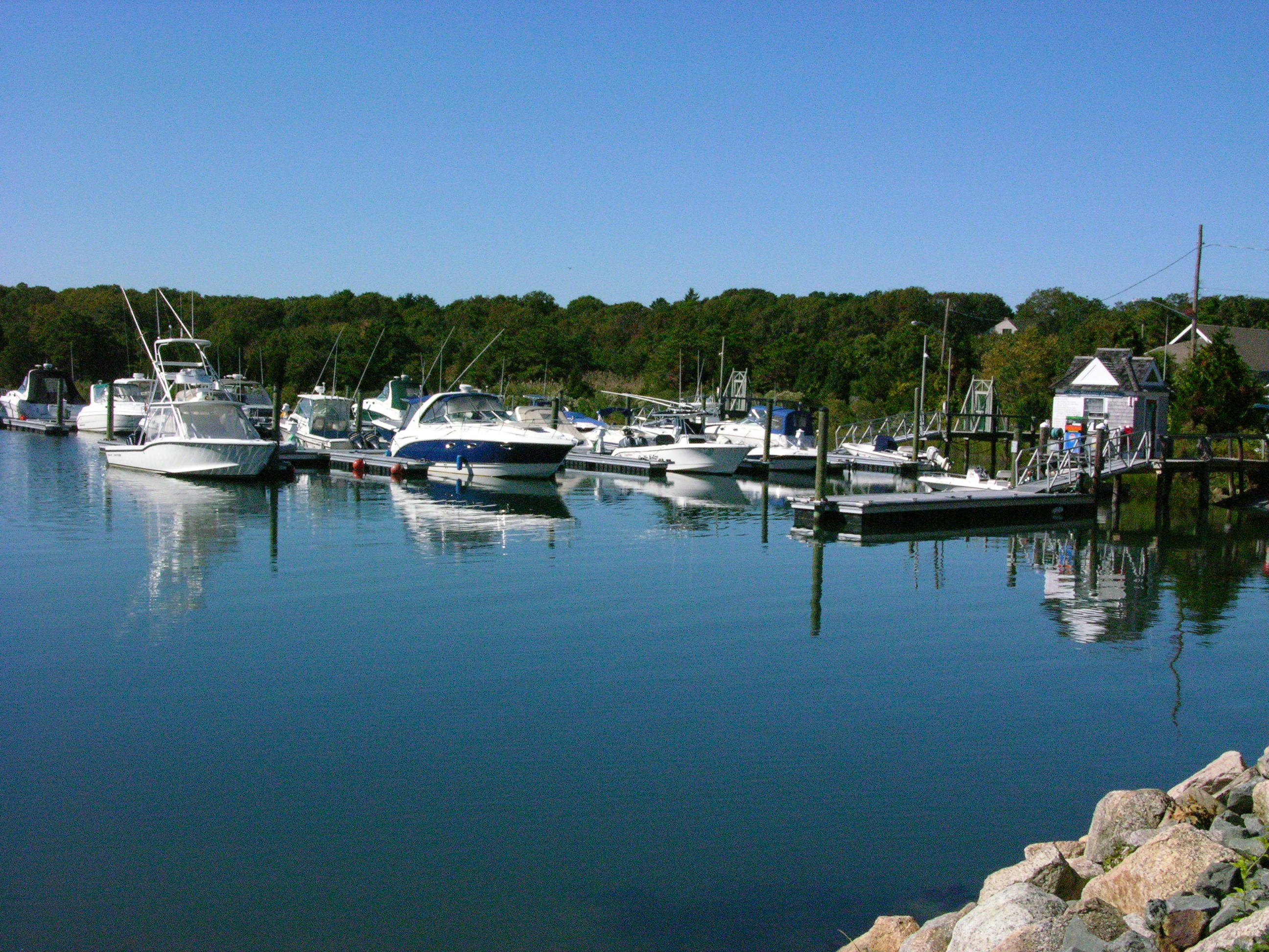 44 Brant Rock Road Mashpee, MA 02649 - Photo 22 of 22 a view of a lake with boats and trees in the background