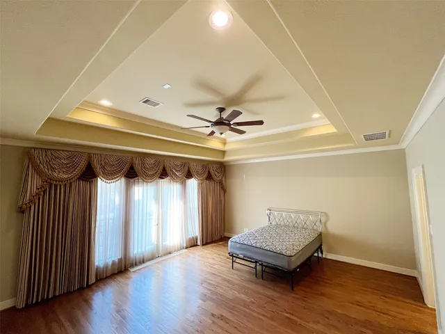 a view of a room with wooden floor and window