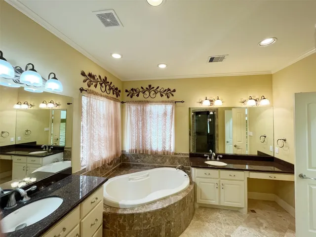 a bathroom with a double vanity sink and a mirror