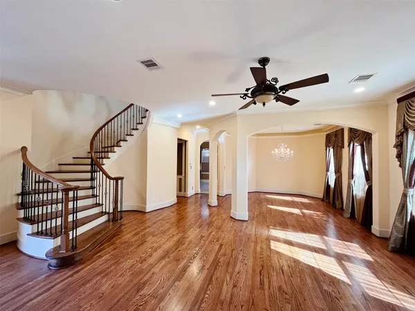 a view of entryway and hall with wooden floor