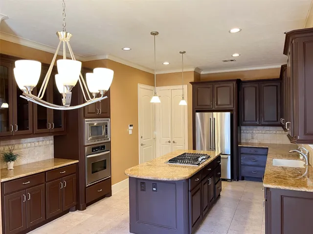 a kitchen with counter top space cabinets and stainless steel appliances