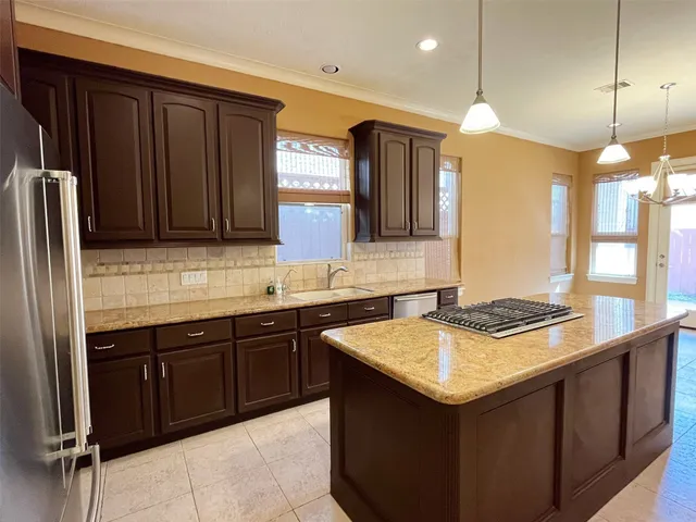 a kitchen with a sink and a refrigerator