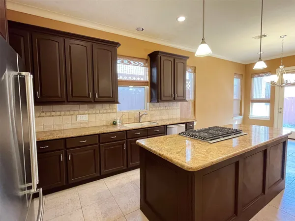 a kitchen with a sink and a refrigerator