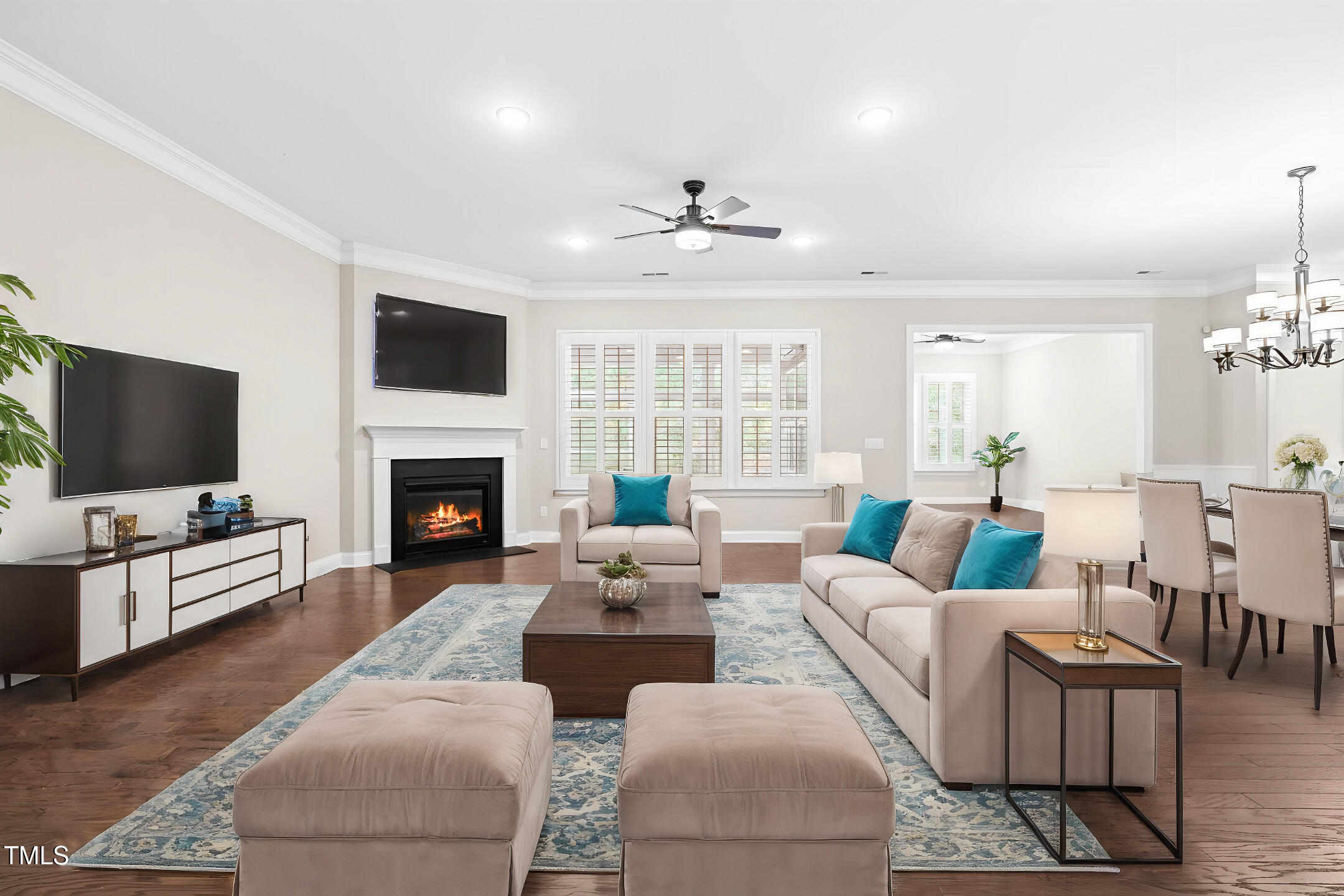 128 Damsire Way Cary, NC 27513 - Photo 13 of 45 a living room with furniture a flat screen tv and a fireplace
