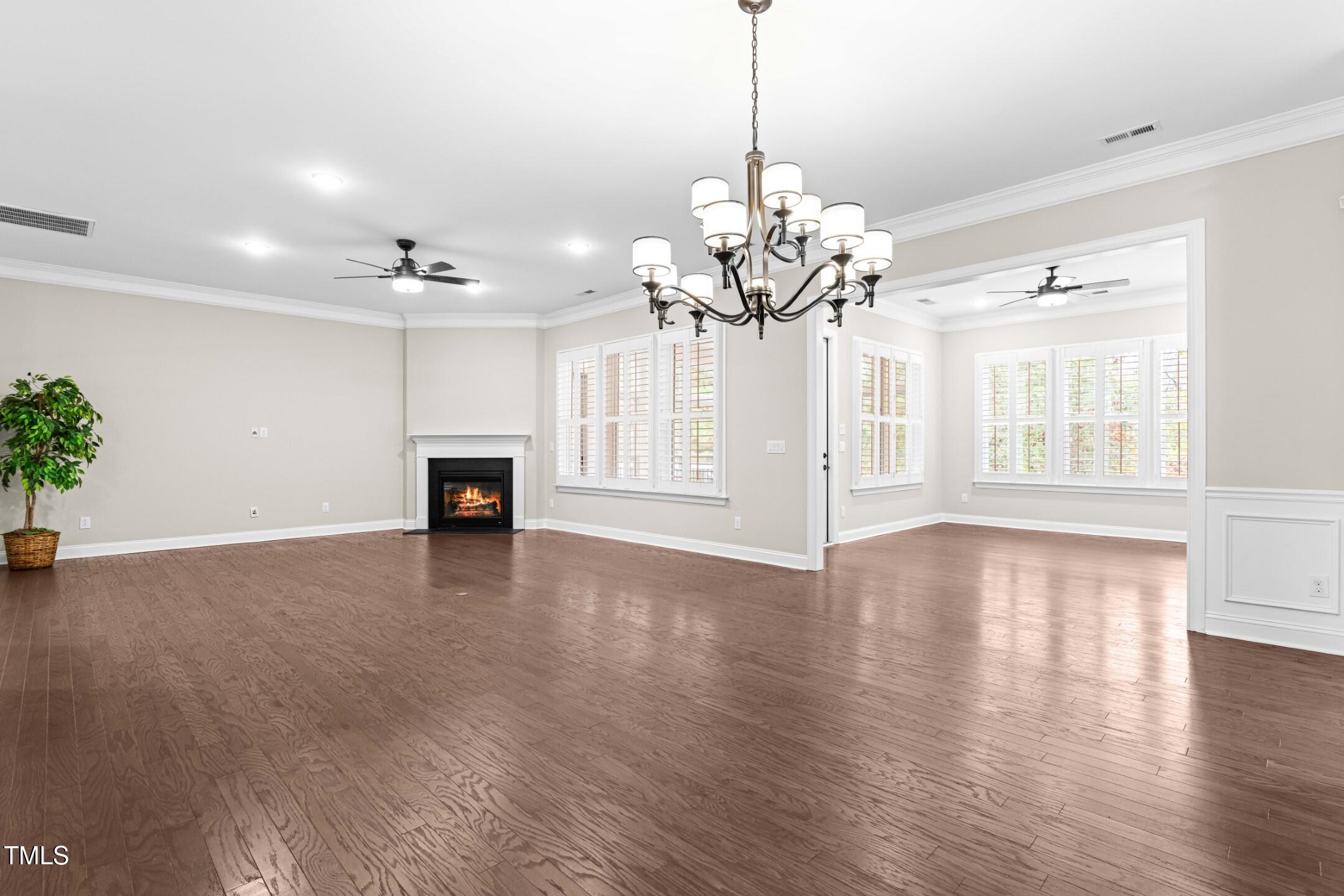 128 Damsire Way Cary, NC 27513 - Photo 15 of 45 a view of a livingroom with wooden floor and a chandelier