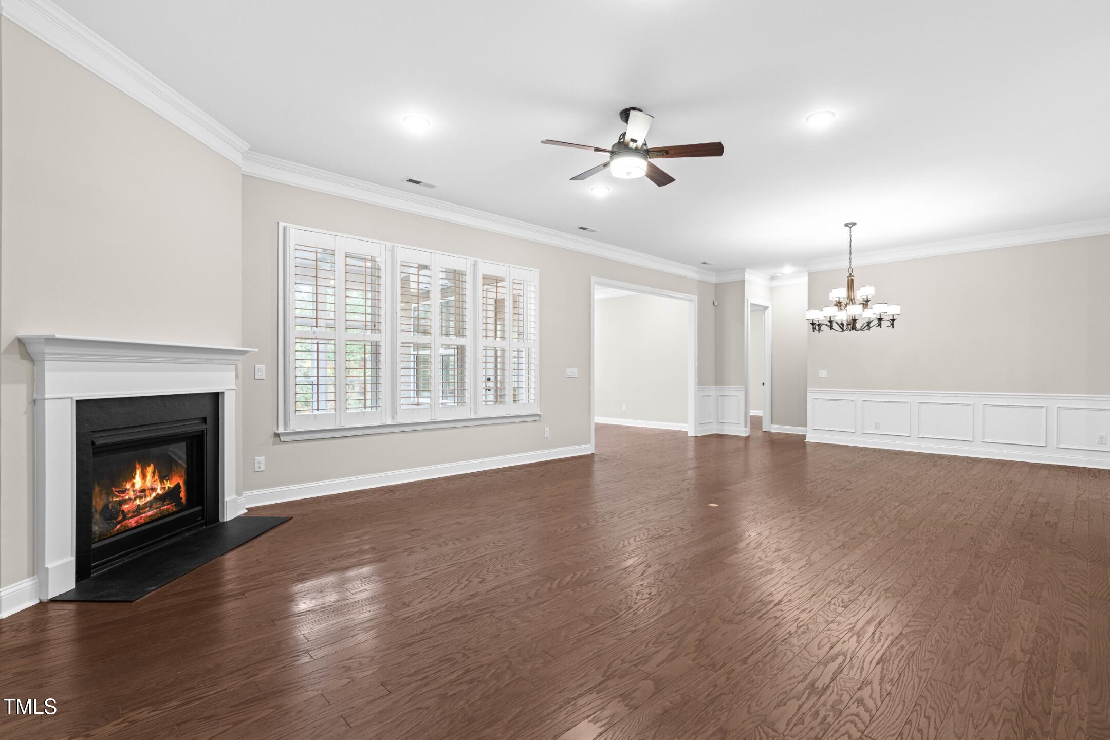 128 Damsire Way Cary, NC 27513 - Photo 16 of 45 a view of an empty room with wooden floor fireplace and a window