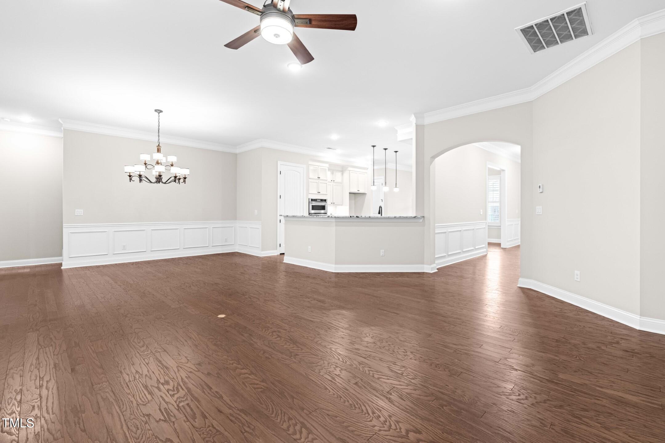 128 Damsire Way Cary, NC 27513 - Photo 17 of 45 a view of a kitchen with wooden floor and a ceiling fan