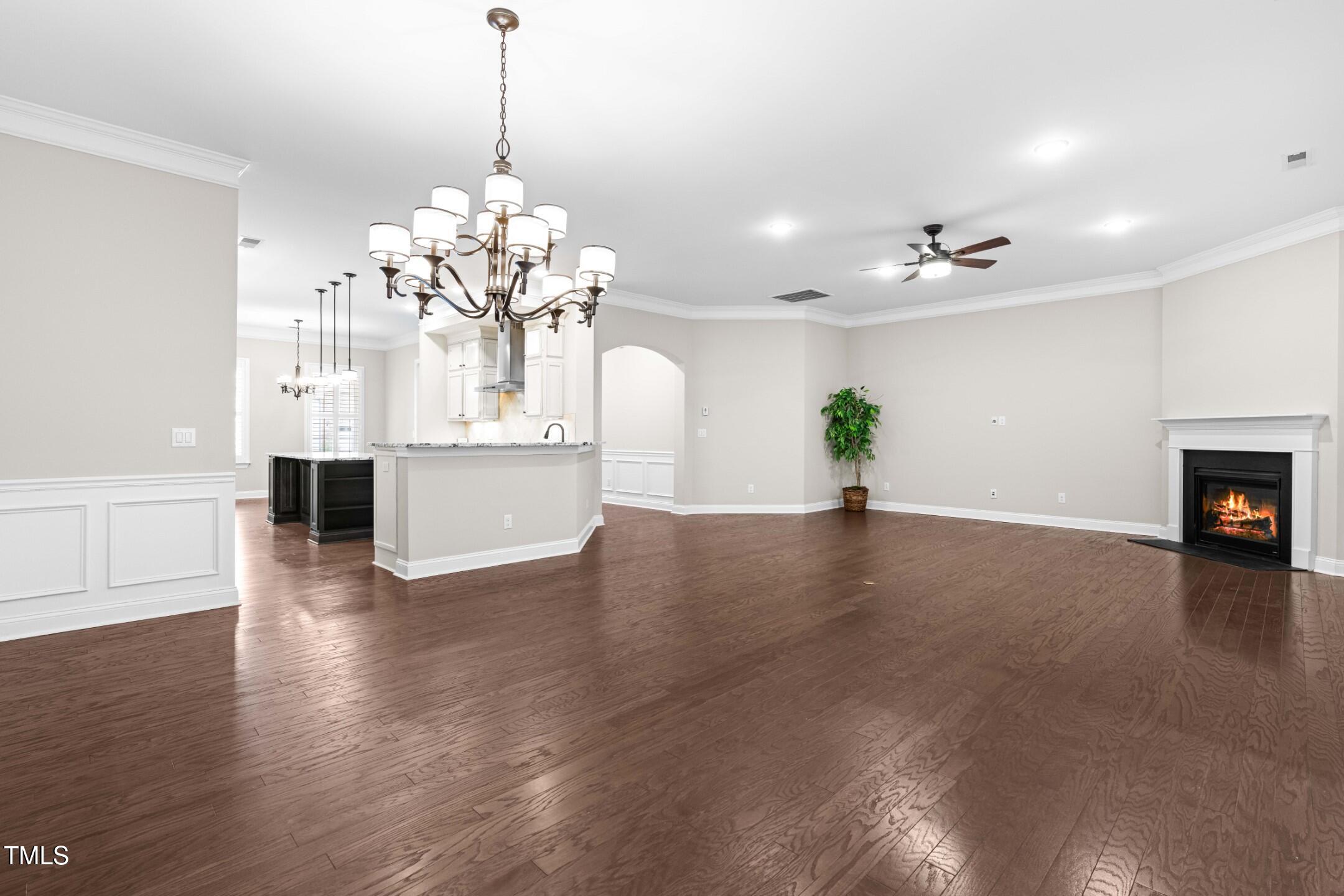 128 Damsire Way Cary, NC 27513 - Photo 18 of 45 a view of a room with wooden floor and a chandelier
