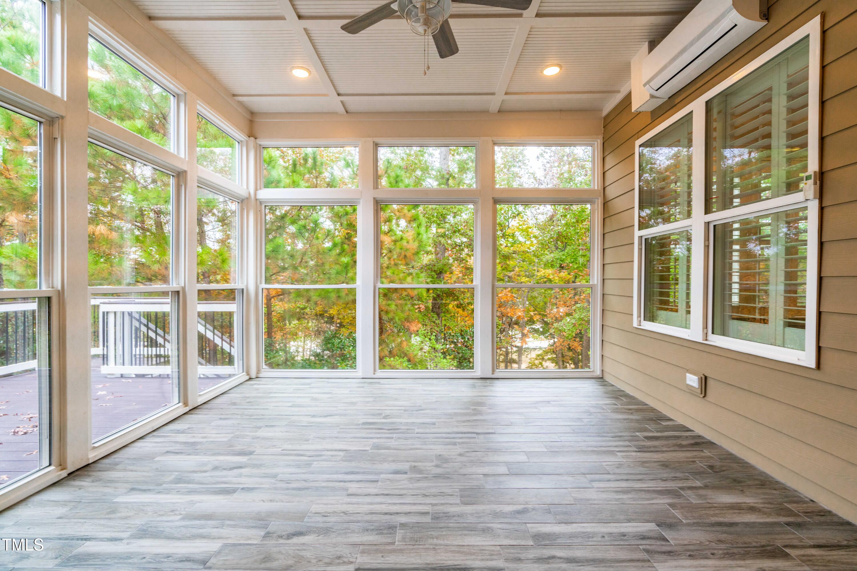 128 Damsire Way Cary, NC 27513 - Photo 23 of 45 a view of an empty room with wooden floor and a large window