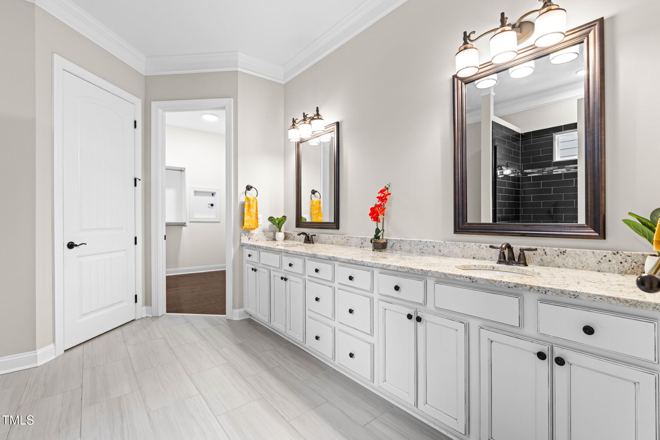 128 Damsire Way Cary, NC 27513 - Photo 27 of 45 a bathroom with double vanity sink and a mirror