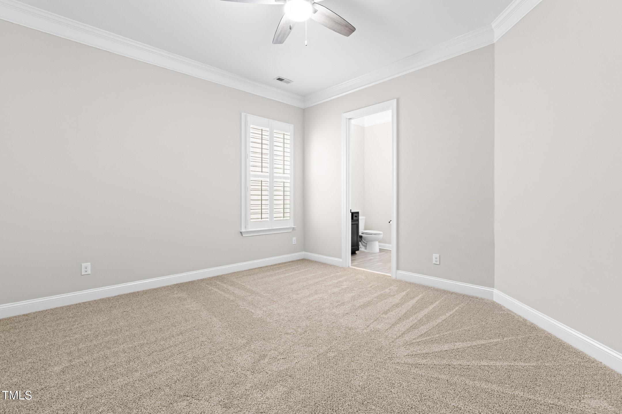 128 Damsire Way Cary, NC 27513 - Photo 33 of 45 an empty room with windows and chandelier fan