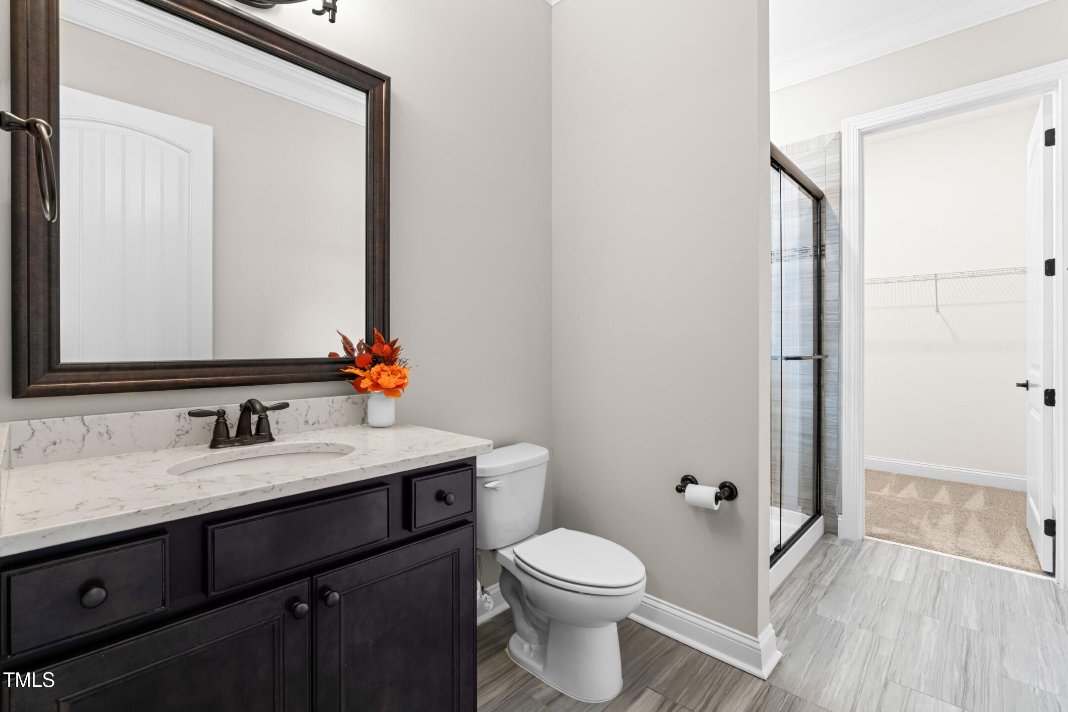128 Damsire Way Cary, NC 27513 - Photo 34 of 45 a bathroom with a granite countertop sink toilet a mirror and shower