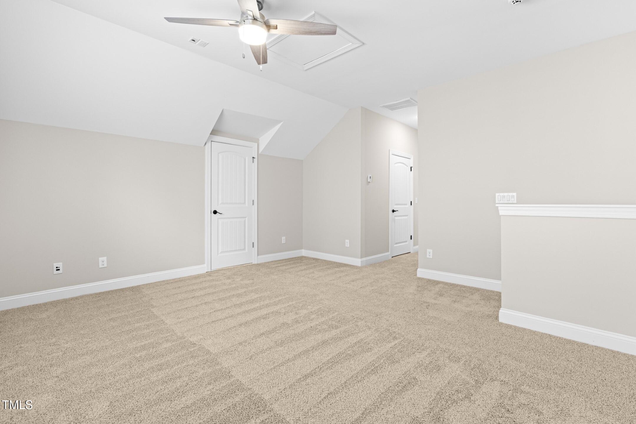 128 Damsire Way Cary, NC 27513 - Photo 37 of 45 an empty room with a chandelier fan and wooden floor
