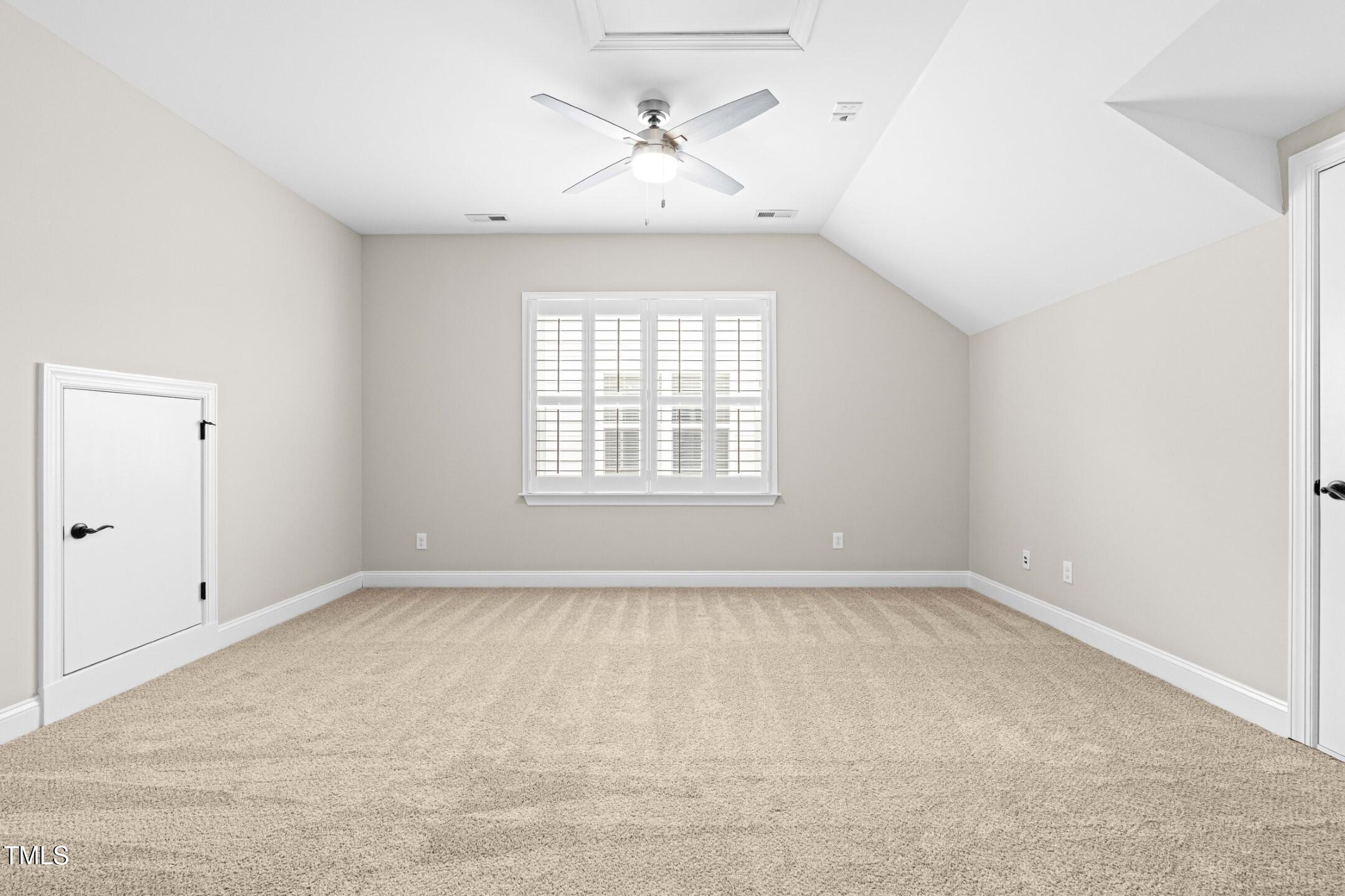 128 Damsire Way Cary, NC 27513 - Photo 38 of 45 an empty room with chandelier fan and windows