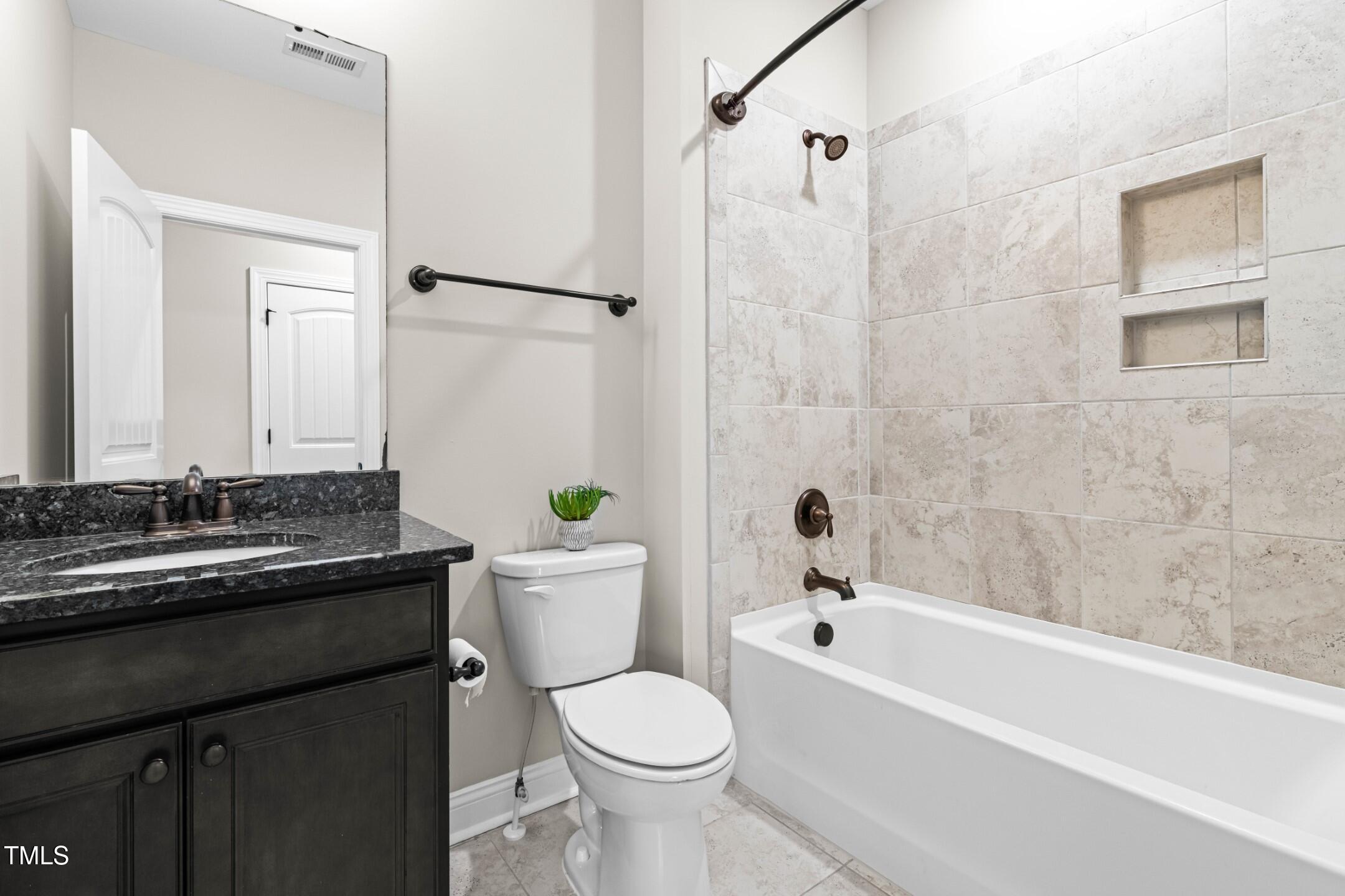 128 Damsire Way Cary, NC 27513 - Photo 41 of 45 a bathroom with a granite countertop toilet sink and bathtub