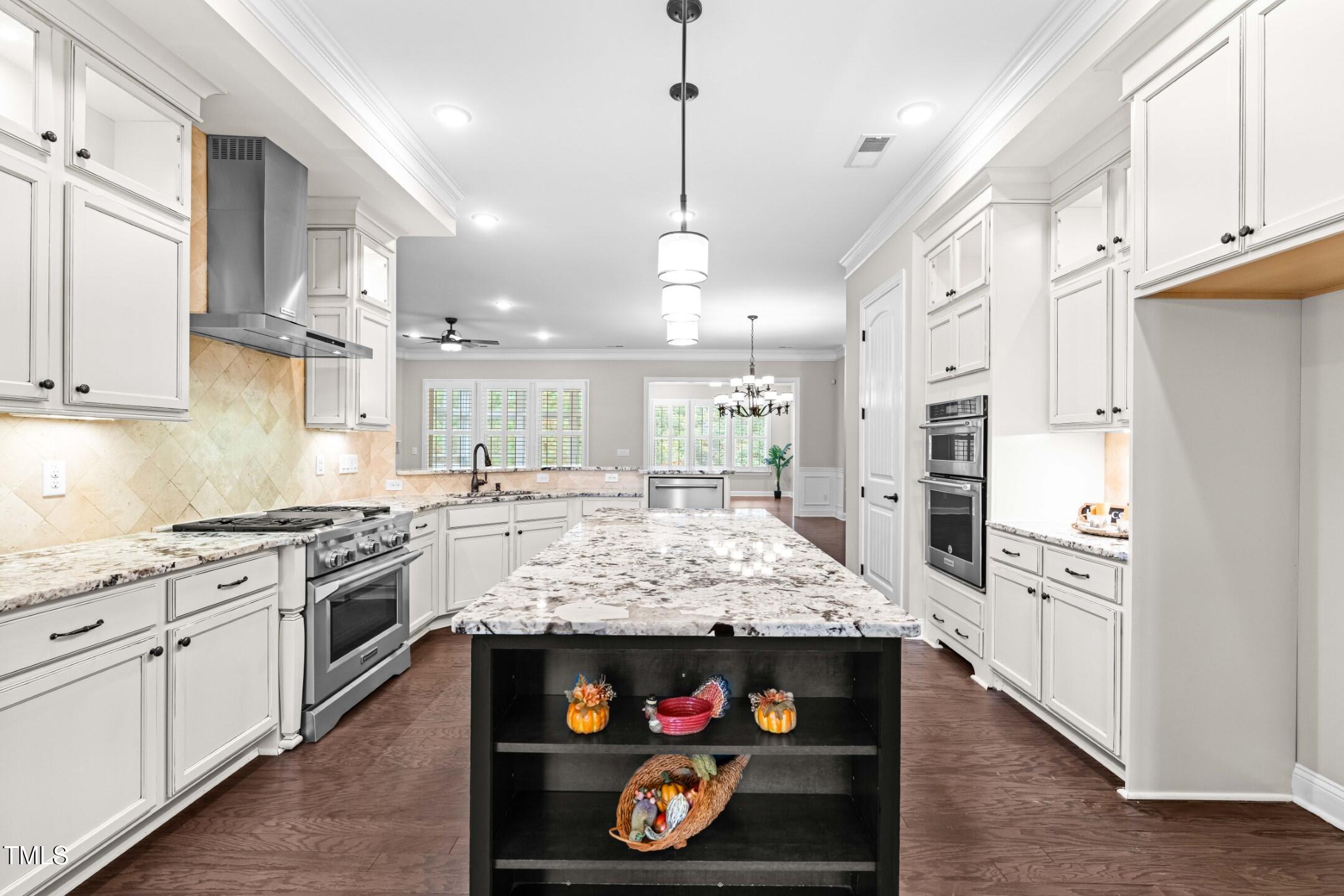 128 Damsire Way Cary, NC 27513 - Photo 8 of 45 a large kitchen with stainless steel appliances kitchen island granite countertop a stove and refrigerator