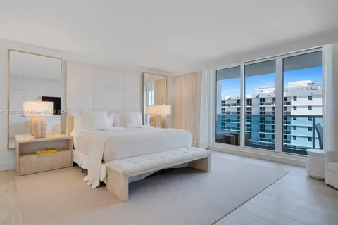 a spacious bedroom with a large bed and a view of walk in closet