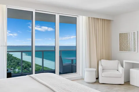 a bedroom with a large bed and a large window