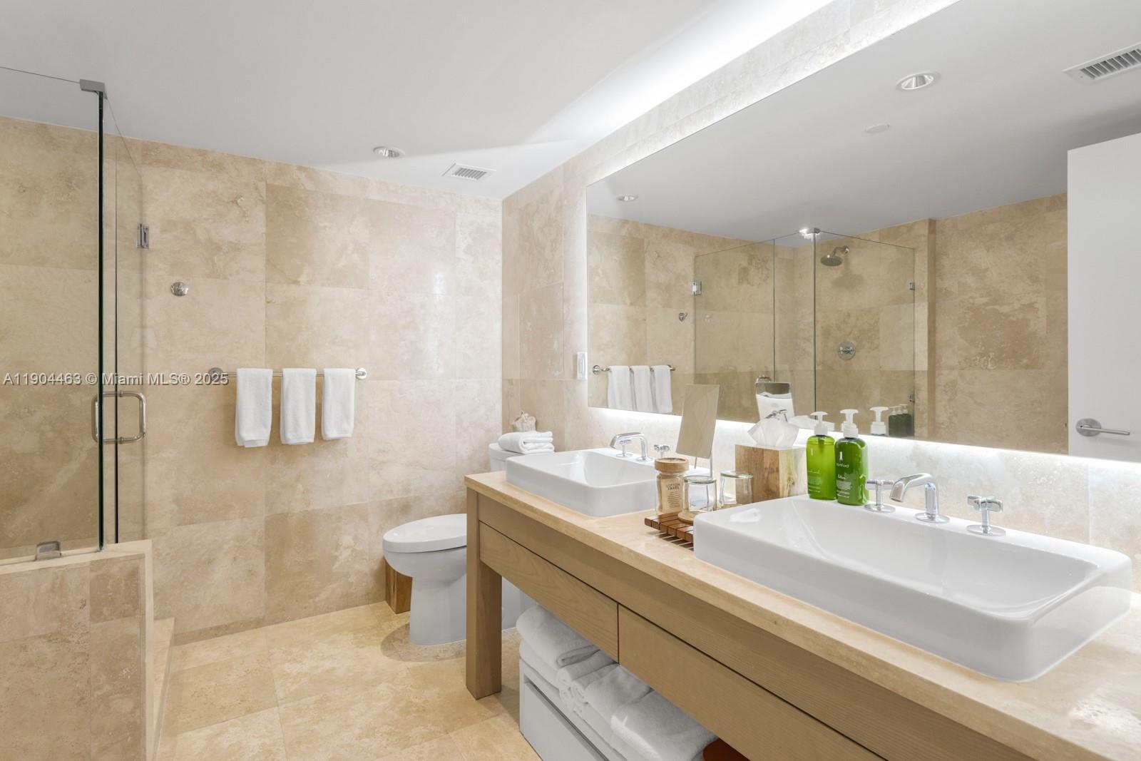 102 24th Street, Unit 1519 Miami Beach, FL 33139 - Photo 18 of 35 a bathroom with a sink and a mirror