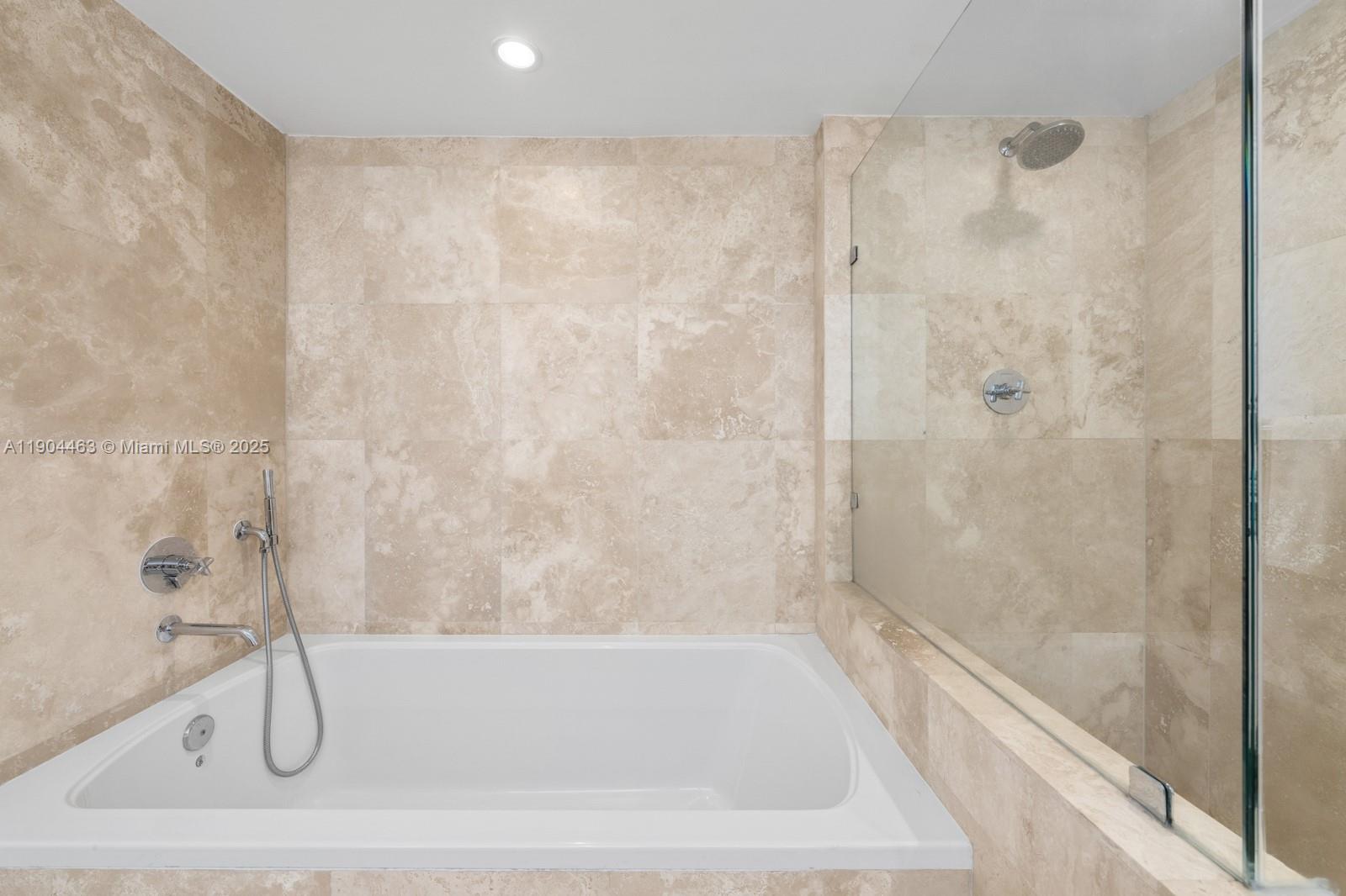 102 24th Street, Unit 1519 Miami Beach, FL 33139 - Photo 19 of 35 a bathroom with a bath tub