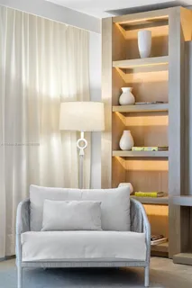 a living room with a couch and a potted plant