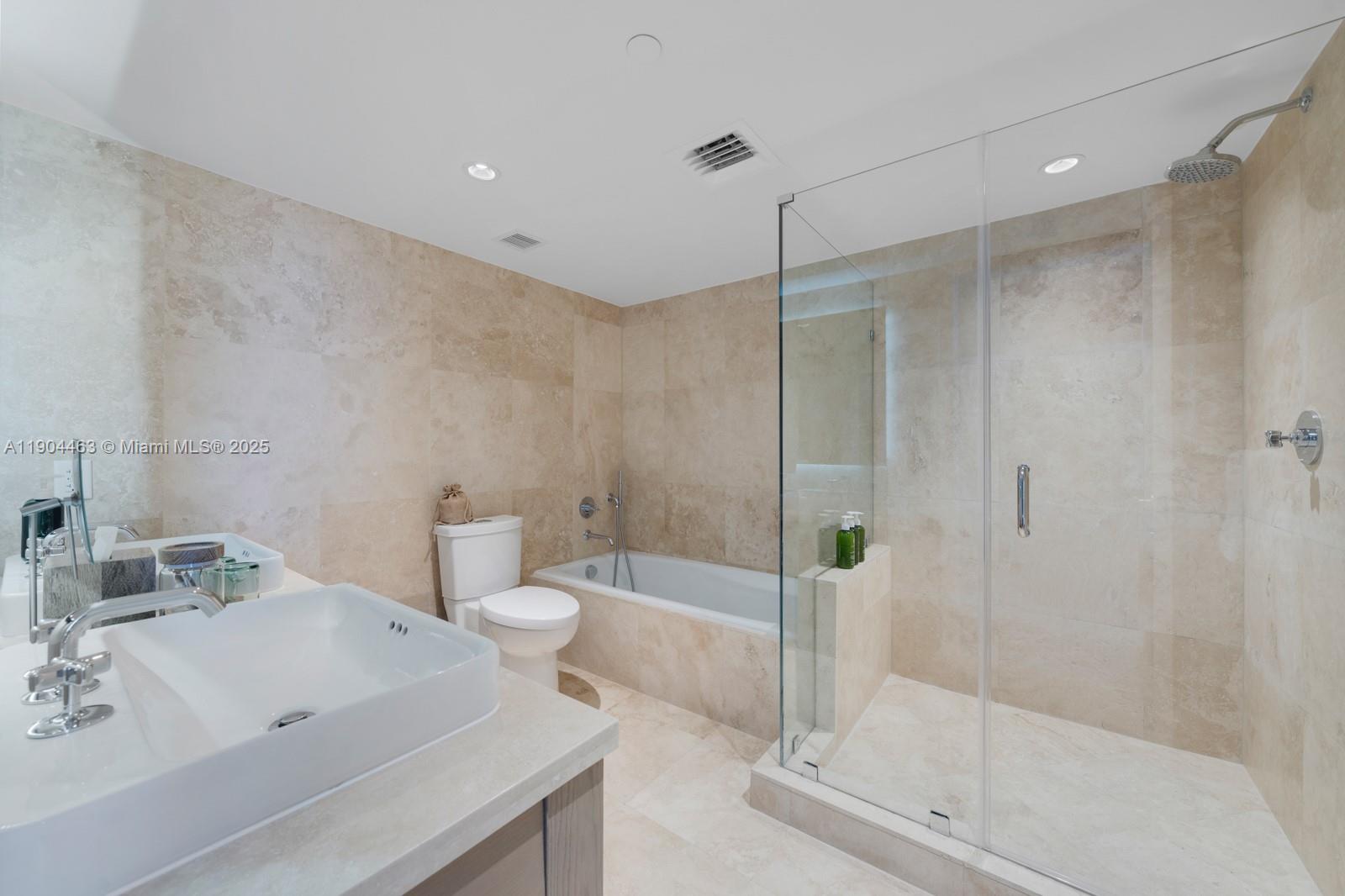 102 24th Street, Unit 1519 Miami Beach, FL 33139 - Photo 5 of 35 a bathroom with a bathtub shower sink and toilet