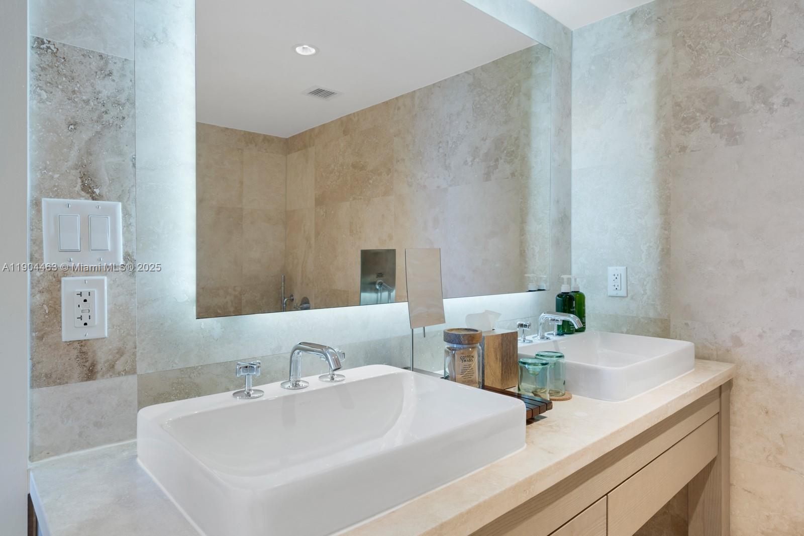 102 24th Street, Unit 1519 Miami Beach, FL 33139 - Photo 6 of 35 a bathroom with a sink and a mirror