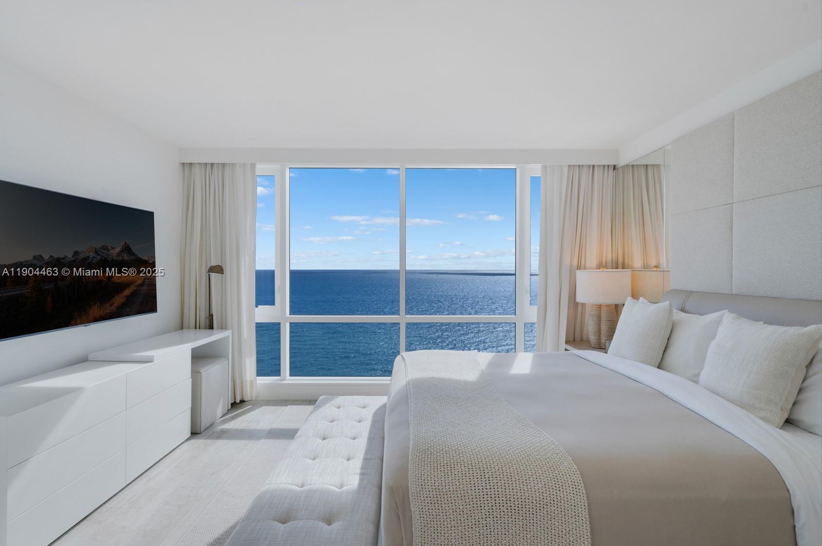 102 24th Street, Unit 1519 Miami Beach, FL 33139 - Photo 9 of 35 a bedroom with a bed and a flat screen tv