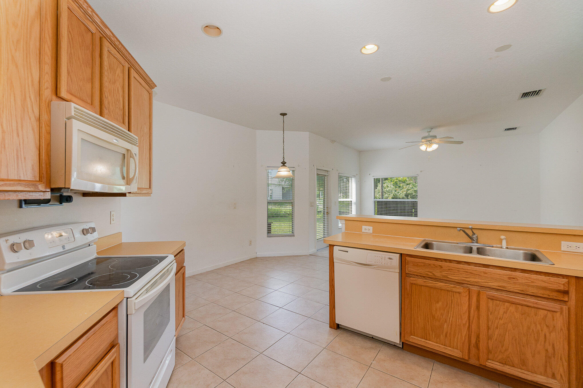 1088 Tupelo Road Southwest Palm Bay, FL 32908 - Photo 11 of 21 a kitchen that has a sink and a stove
