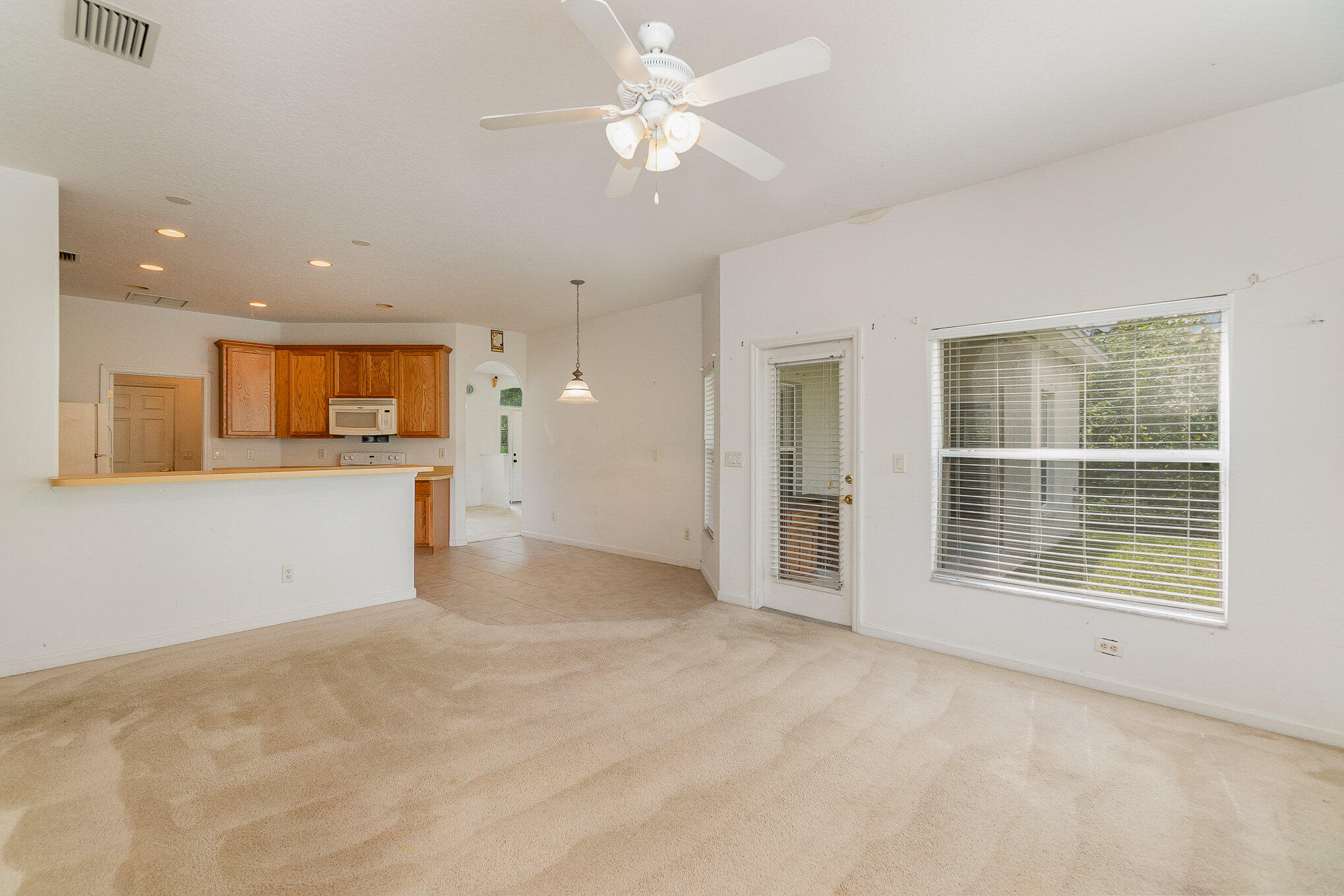 1088 Tupelo Road Southwest Palm Bay, FL 32908 - Photo 7 of 21 a view of an empty room with a window and kitchen view